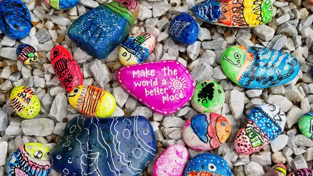 Painted pebbles with slogans on