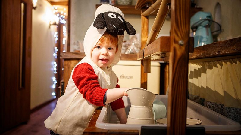 A young boy on a sheep costume