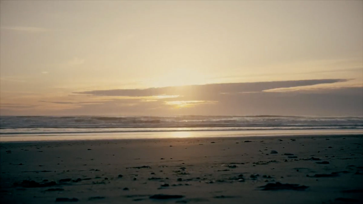 Sunrise on the horizon at an empty beach
